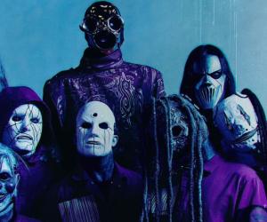A group photo of Slipknot's 2024 lineup against a blue backdrop 