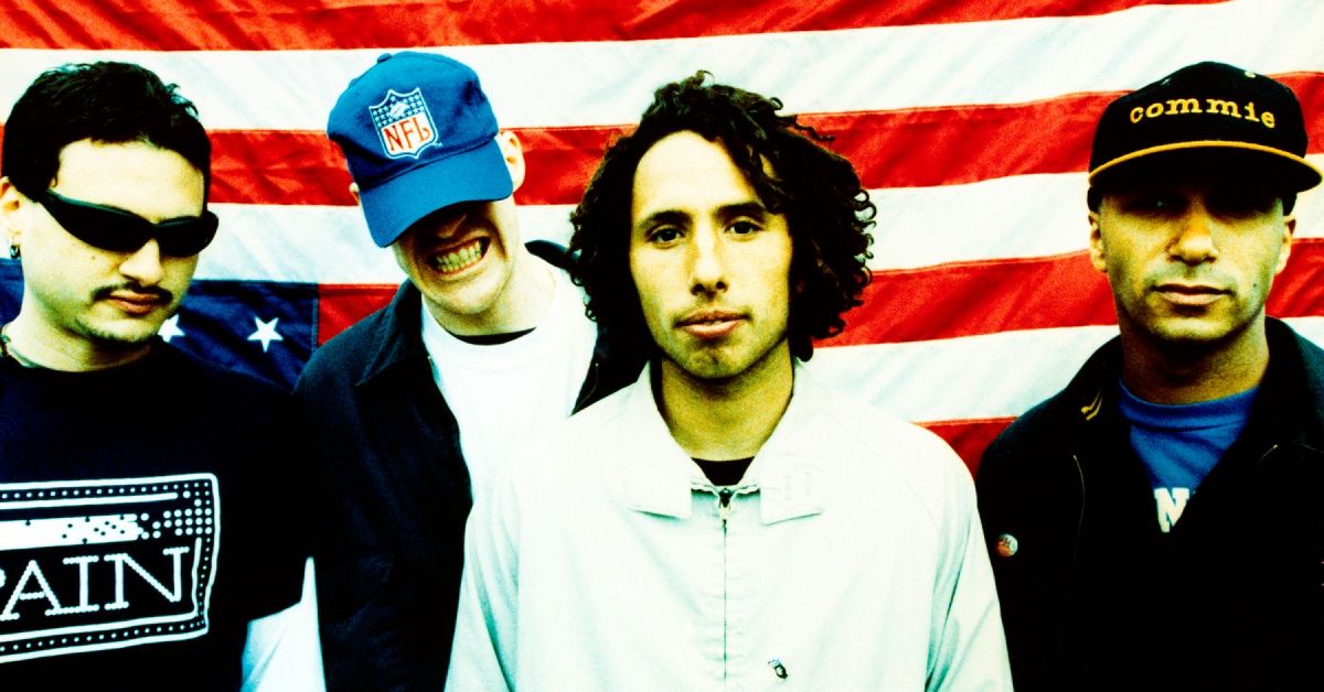 Rage Against The Machine photographed in front of a USA flag.