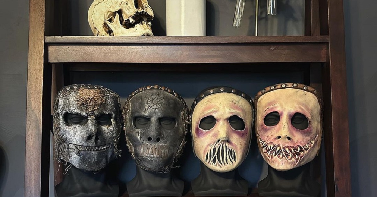 The four masks Jay Weinberg wore in Slipknot displayed on a shelf. 