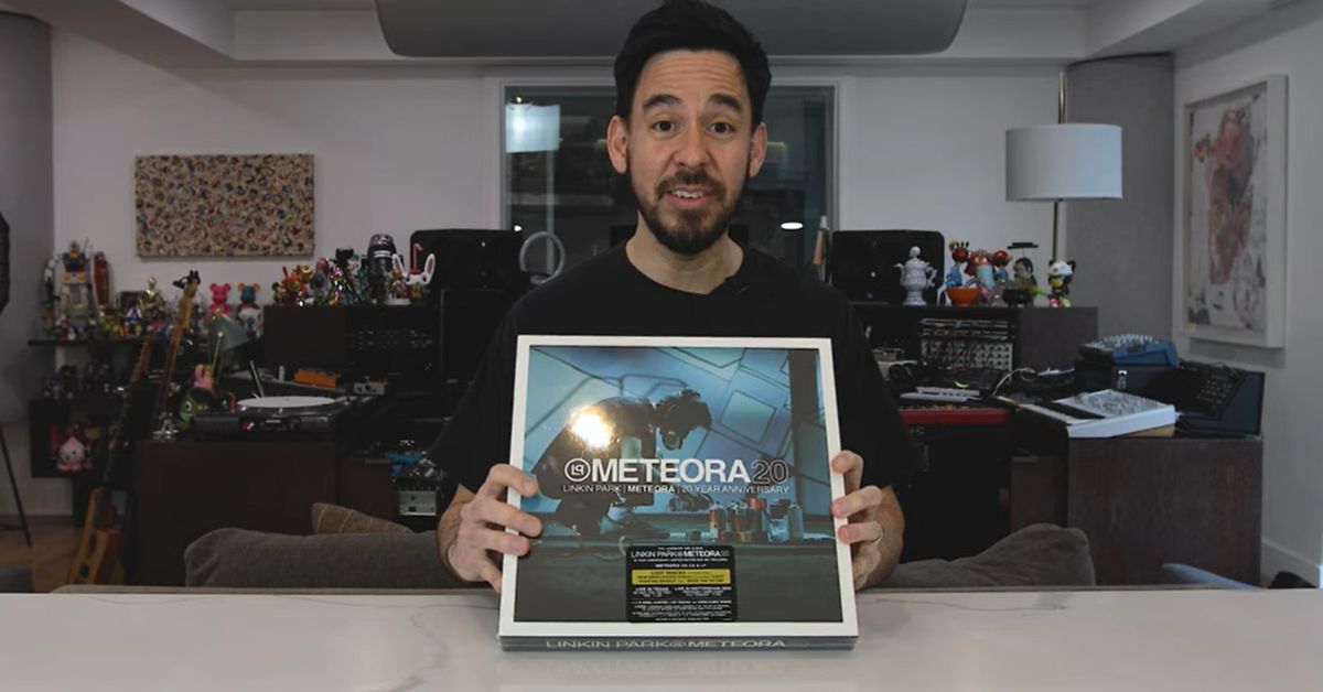 Mike Shinoda holding the box of the Super Deluxe Box Set of Meteora