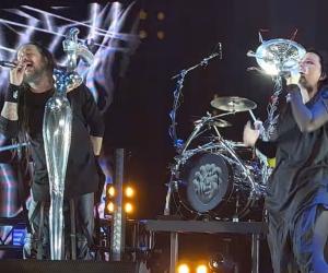 A screenshot of a live performance by Korn and Amy Lee.