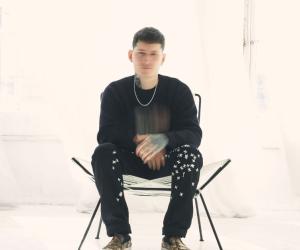 A photo of nothing, nowhere. sitting on a chair in a white room