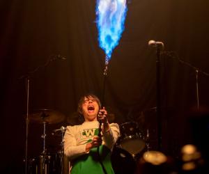 My Chemical Romance lead vocalist Gerard Way shoots flames out of a flame thrower. Photo credit: Allen J. Schaben / Los Angeles Times via Getty Images)