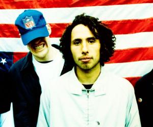 Rage Against The Machine photographed in front of a USA flag.