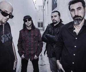 A photo of System of a Down standing in a white hallway